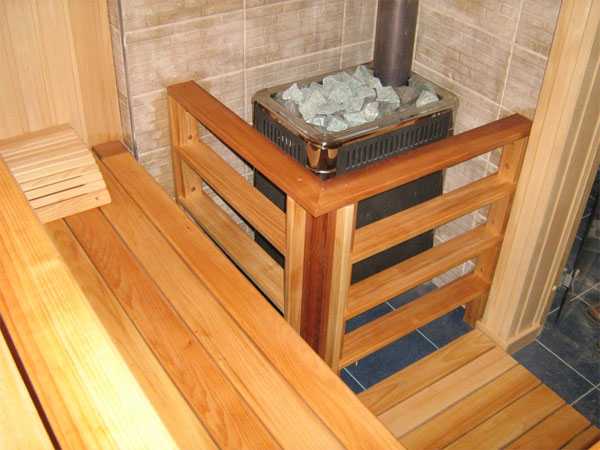 Wooden fence for a sauna stove