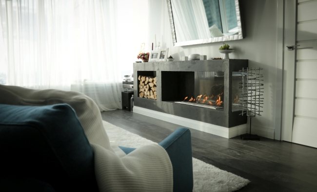 Chest of drawers in the form of a fireplace in the room