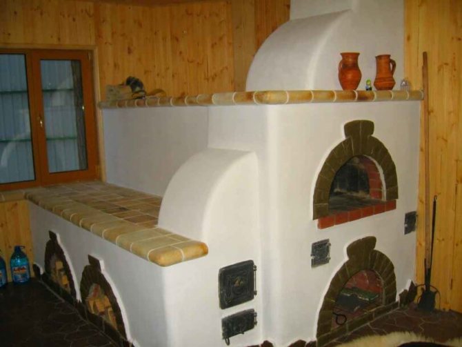 Russian stove finished with plaster and decorative tiles