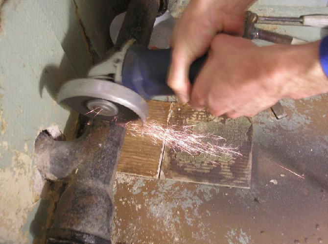 cutting a pipe with a grinder